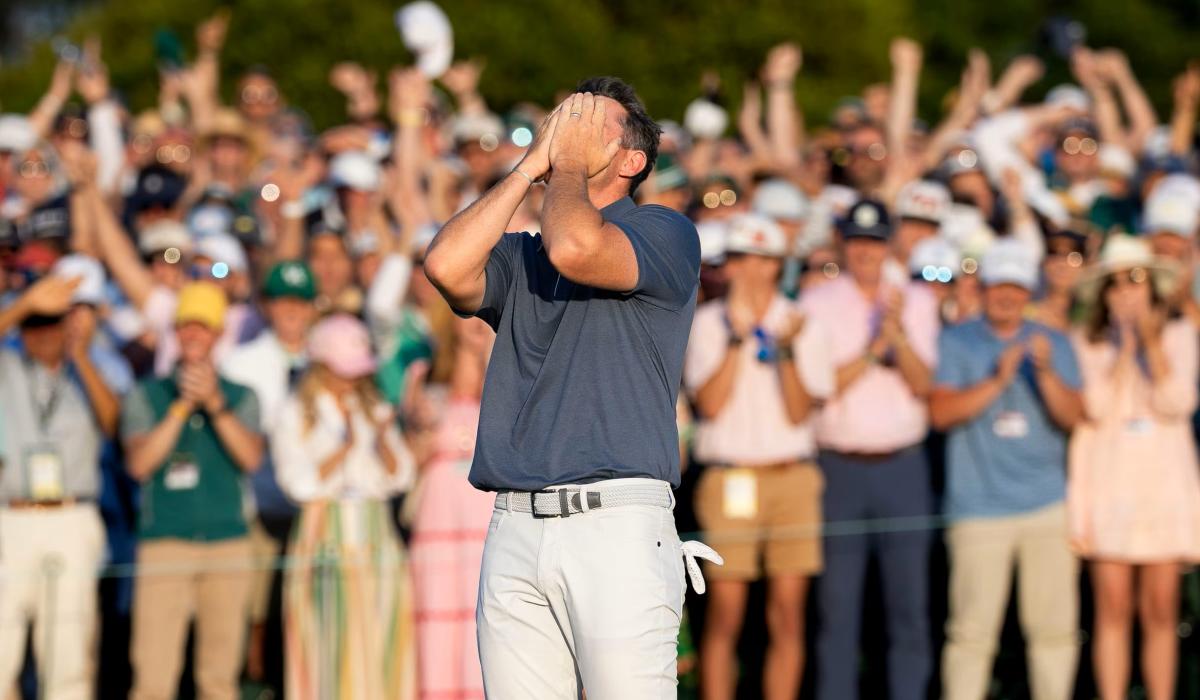 A golf clutches his face after winning a competition