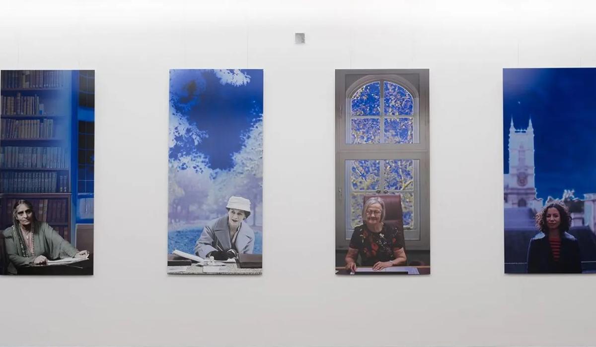 A paiting shows four panels featuring women lawyers over a century