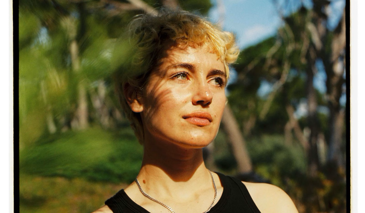 A woman stares away from the camera
