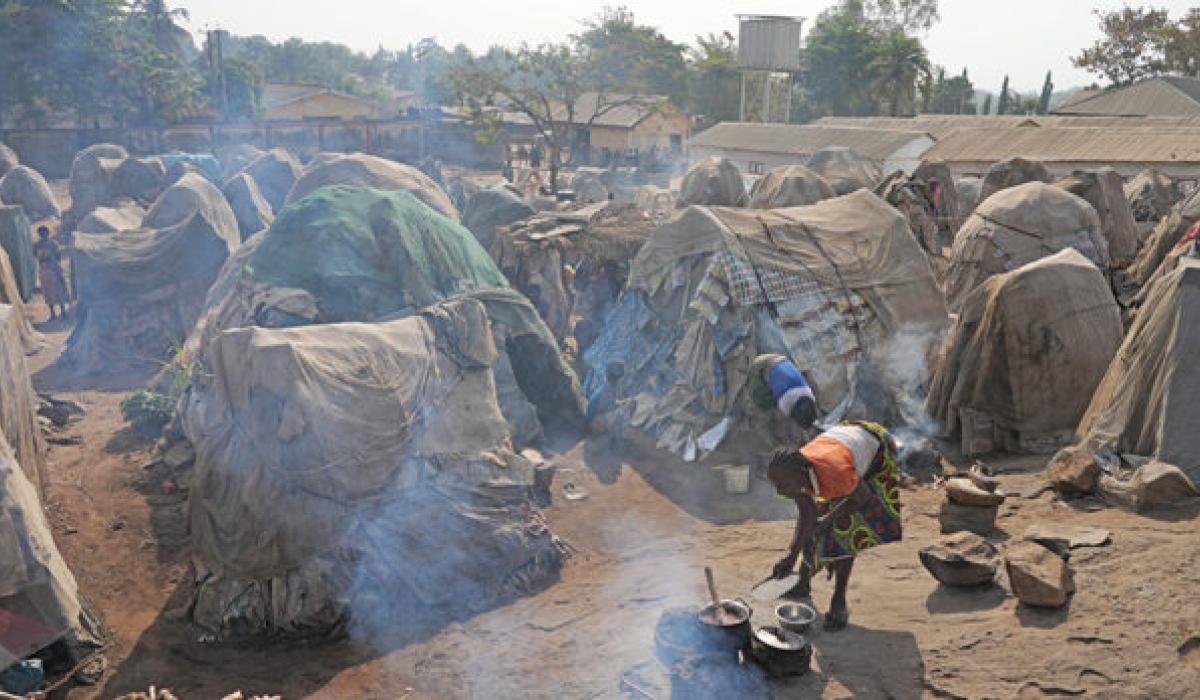 Small huts in a crowded refugee camp.