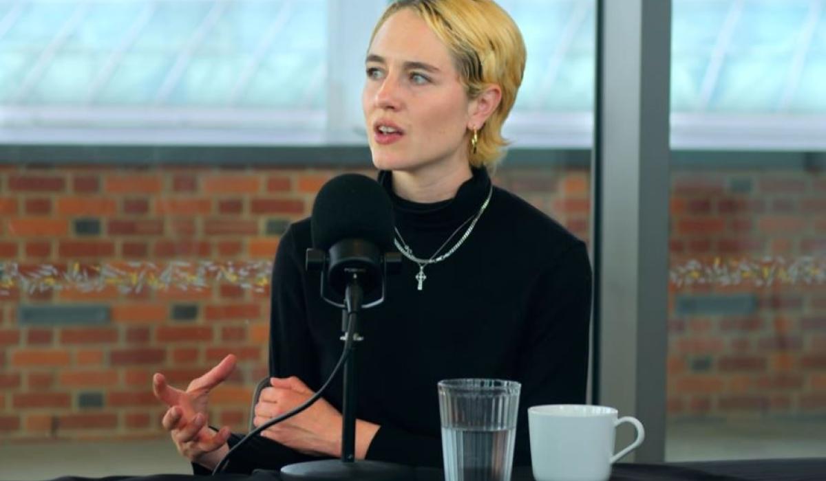 A podcast guest gestures with her hand while talking