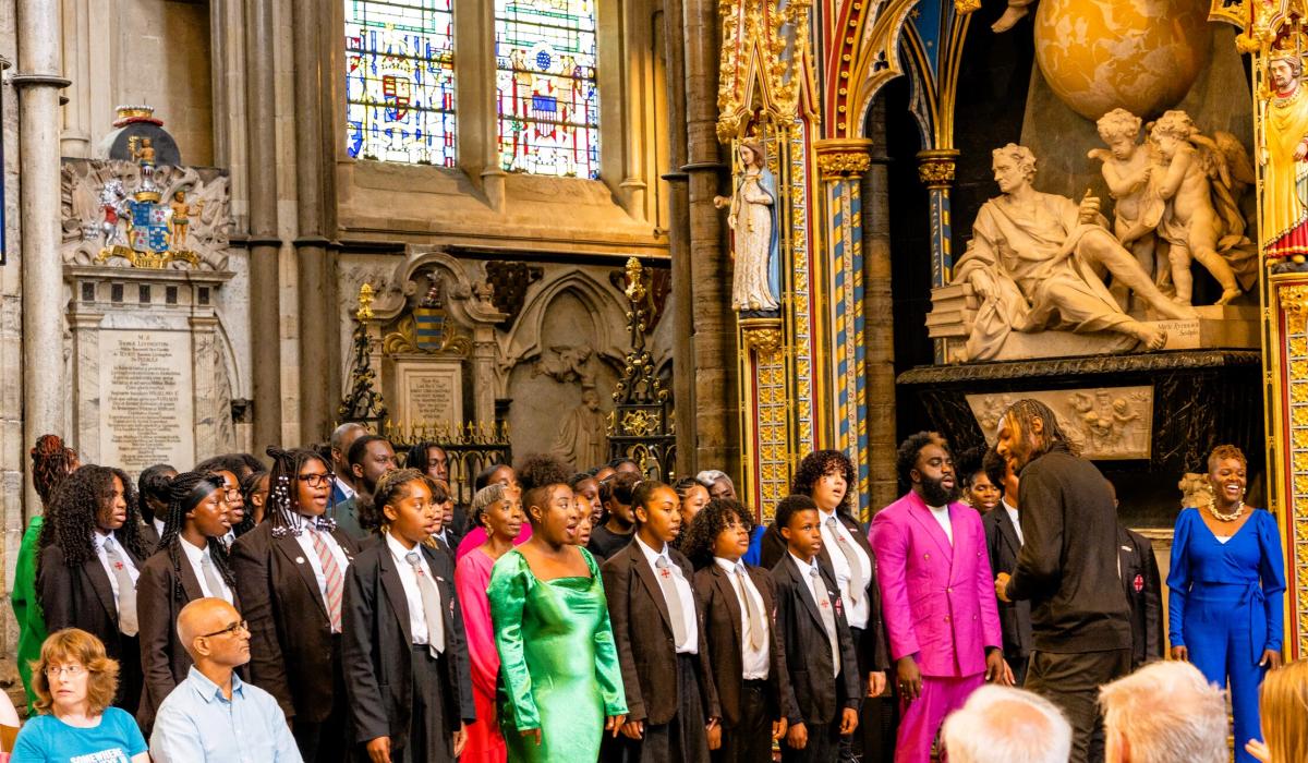 A school choir sings in an ornate abbey setting