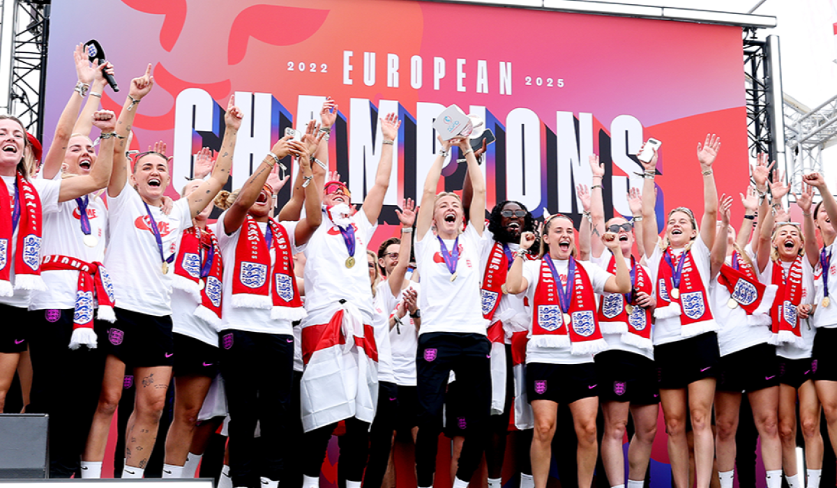 A victorious women's football team celeberate.