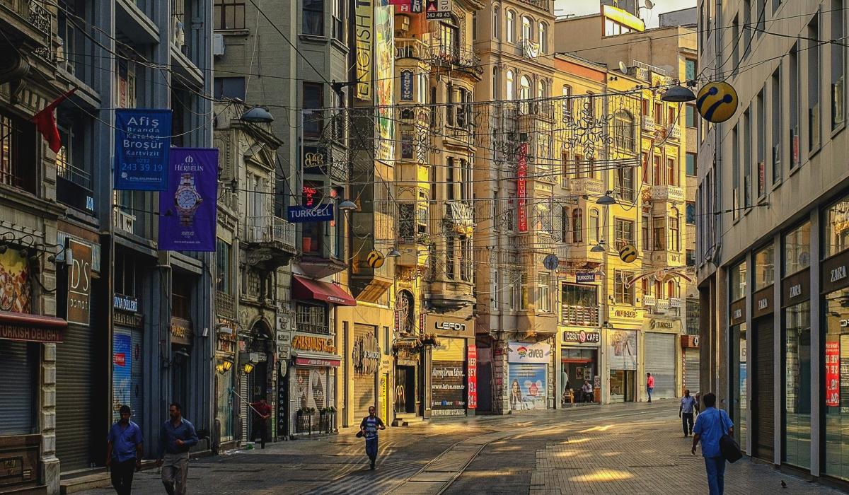 An Istanbul street curves and the sun illuminates one side