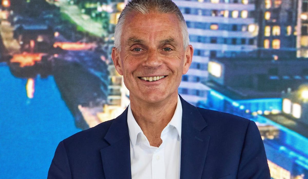 Tim Davie in a blue suite smiles