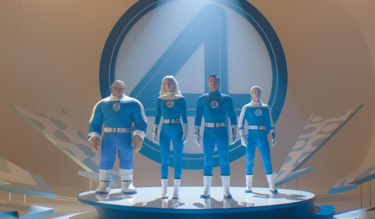 THe Fantastic Four stand on a podium