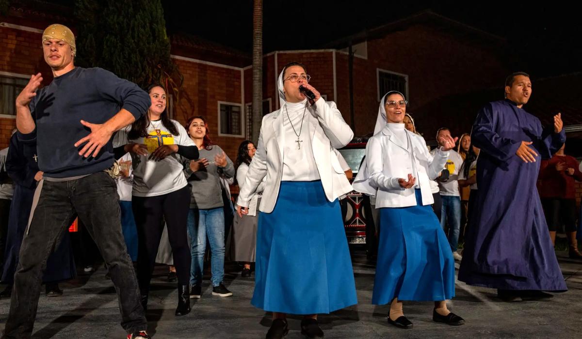 Two nuns with a band rap on stage