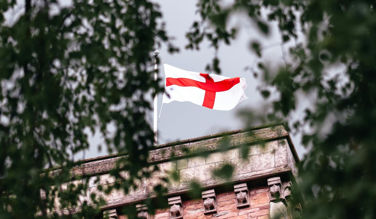 An English flag flies on a church tower.