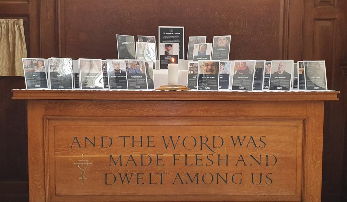 A church altar holds commemorative frames of killed journalists