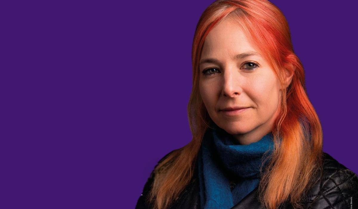 A head and shoulder image of Alice Roberts against a purple background