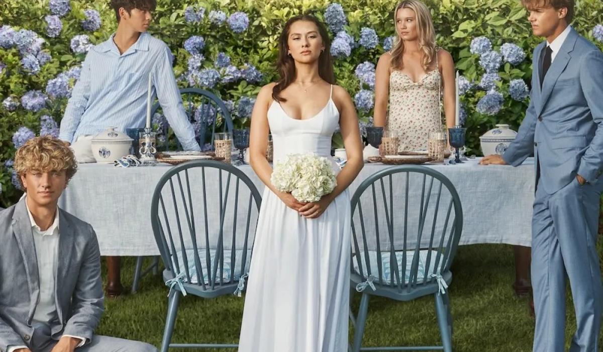 The cast of The Summer I Turned Pretty pose on a wedding set.