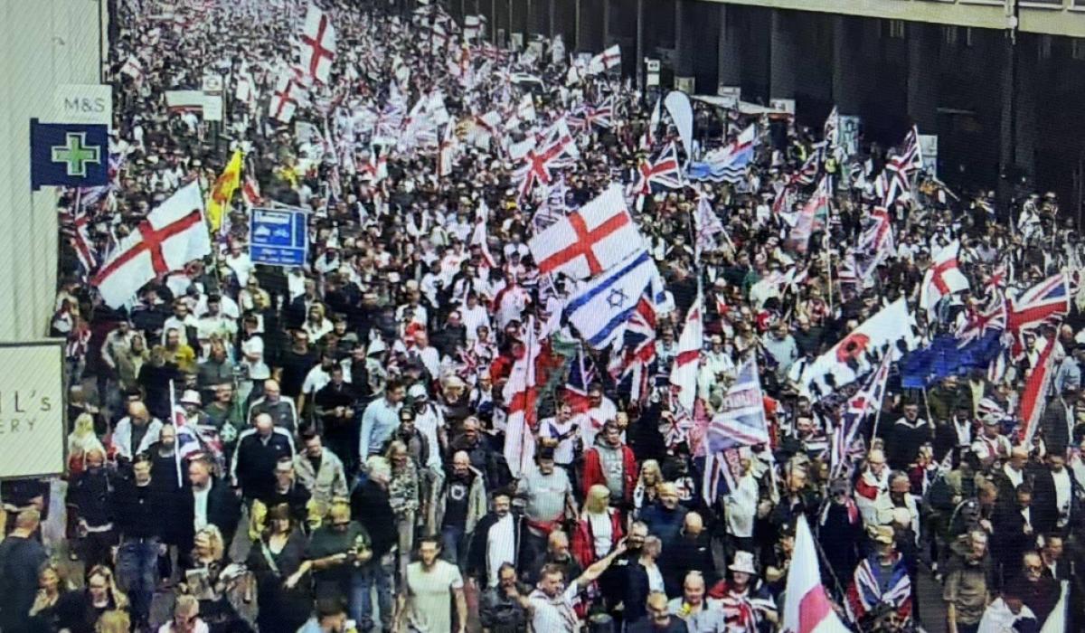 Marchers carry British, English and Israeli flags