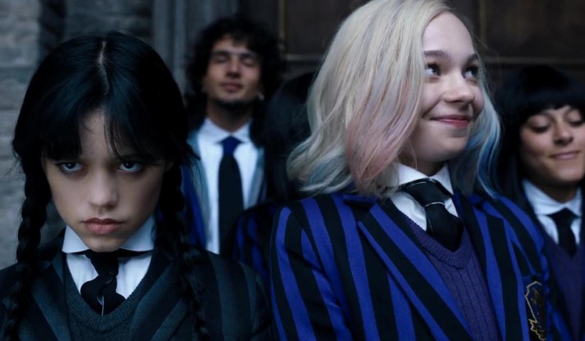 Wednesday Adams scowls while Enid smiles.