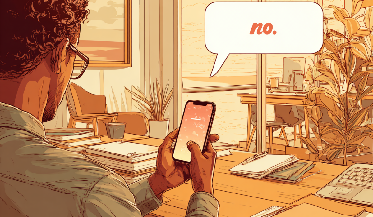 A person hold their phone on their desk, a think bubble from it says 'no'.