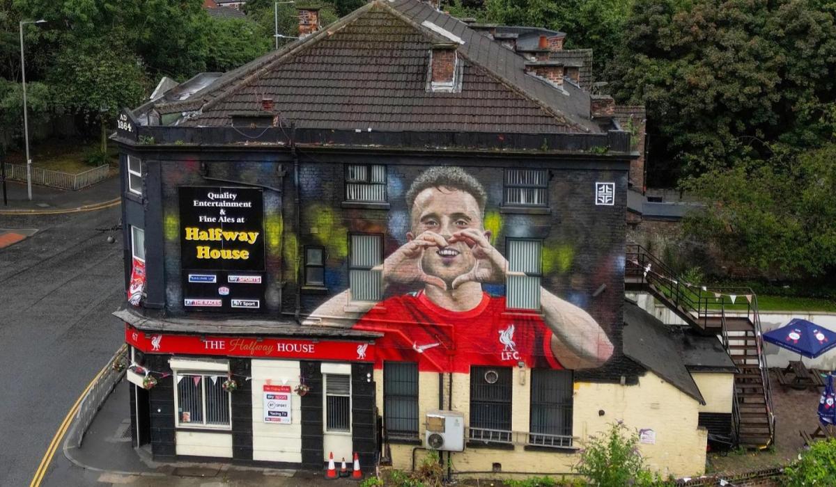 An aerial view of a pub with a large mural of a footballer on it