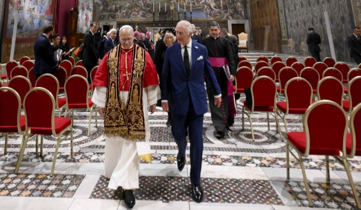 The Pope and King Charles walk together from the Sistine Chapel