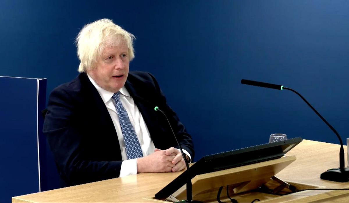 Boris Johnson sits, giving evidence to an inquiry.