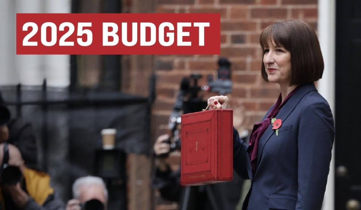 Rachel Reeves holds a red briefcase up.