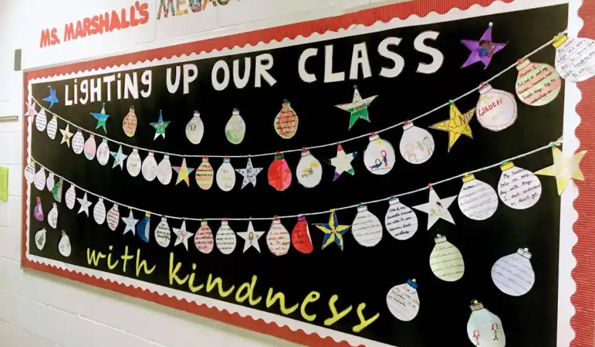 A classroom display of Christmas baubles under a banner.