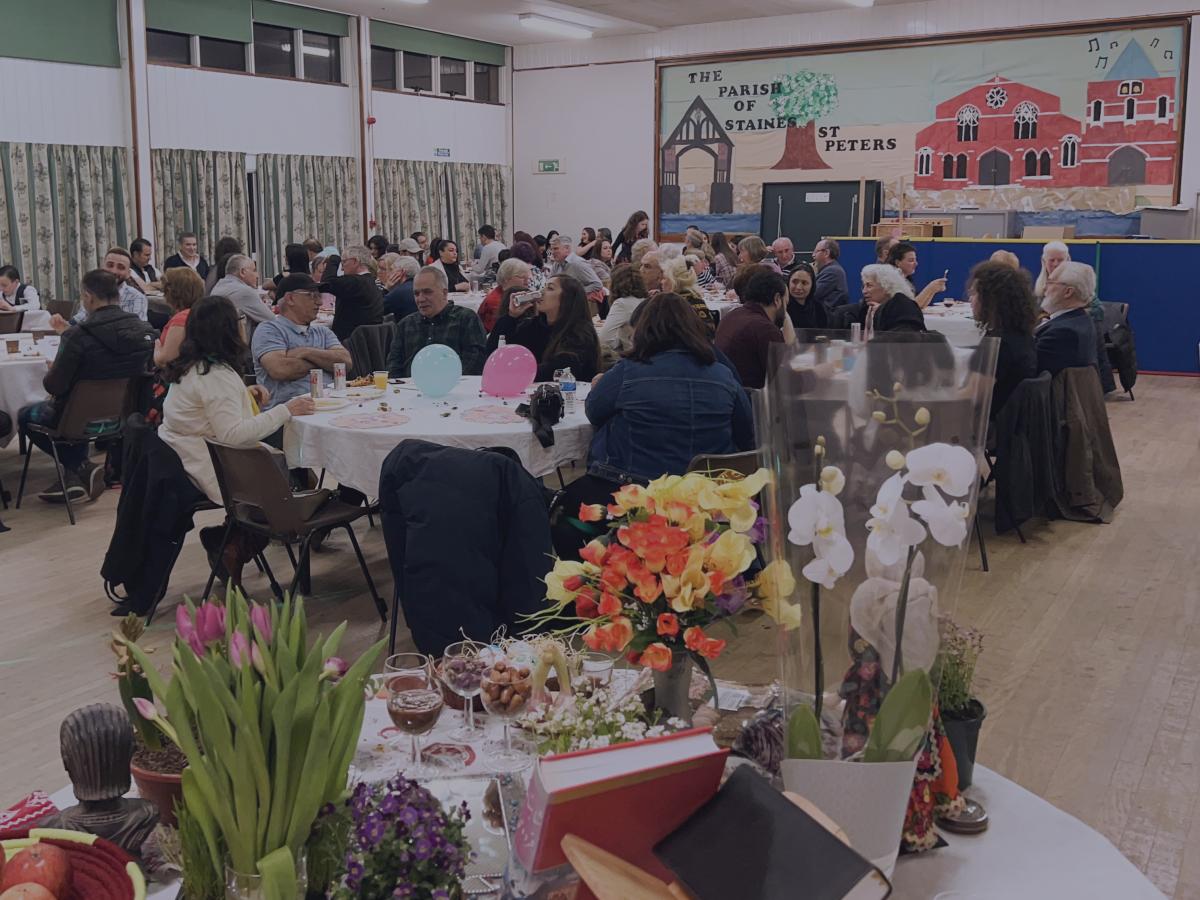 Community members celebrate at lunch in a church hall