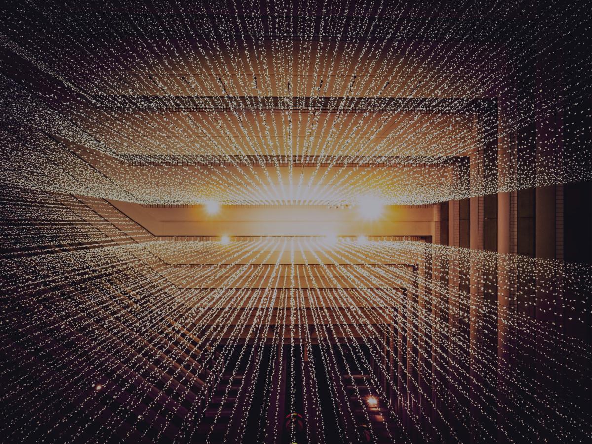 A CGI render of a grid of golden lines receding into the perspective