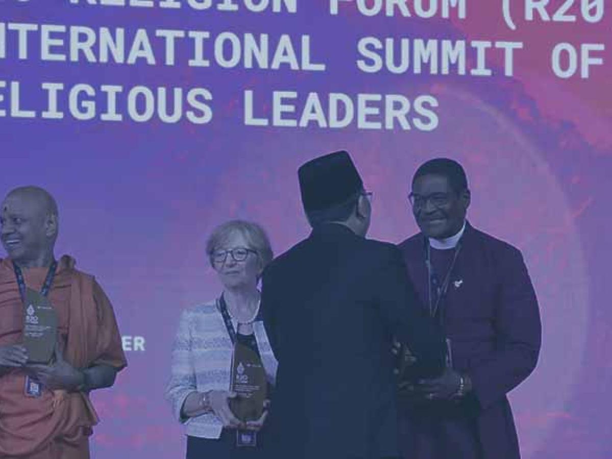 Swami Govinda Dev Giri Maharaj, Dr. Valeria Martano, and Archbishop Henry Ndukuba, are greeted by R20 founder Yahya Cholil Staquf.