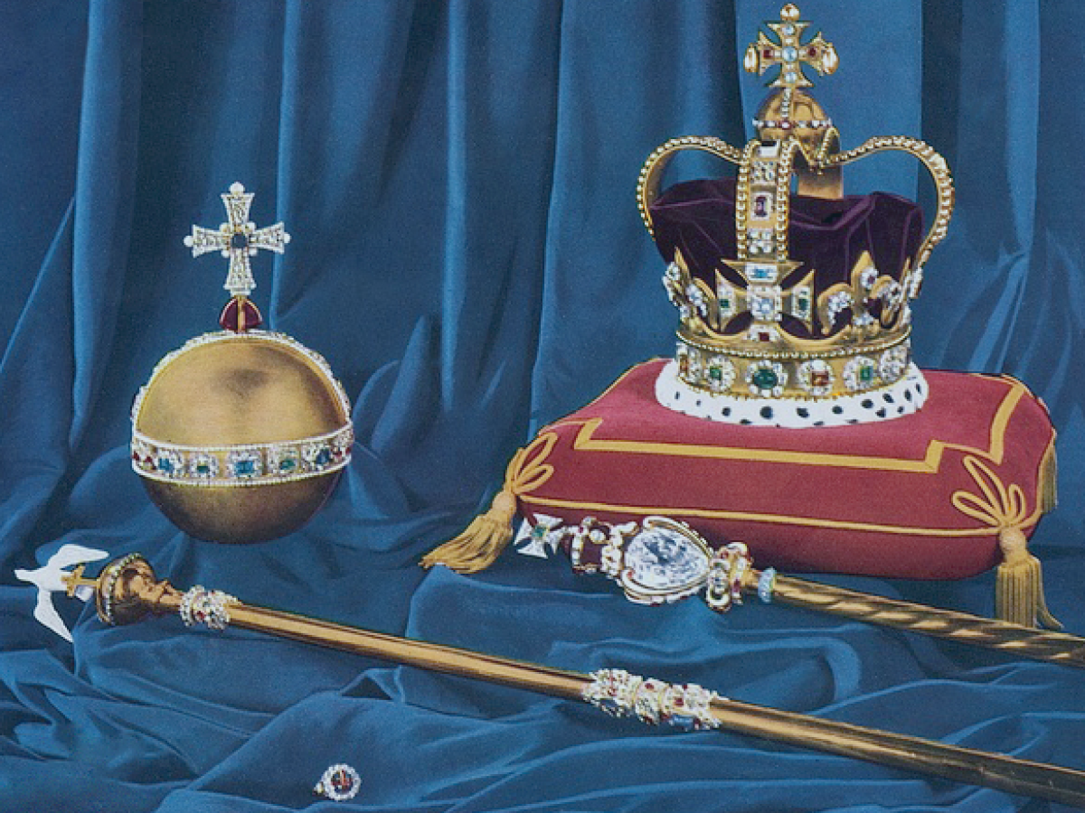 A crown, orb and sceptre rest on velvet cushions.