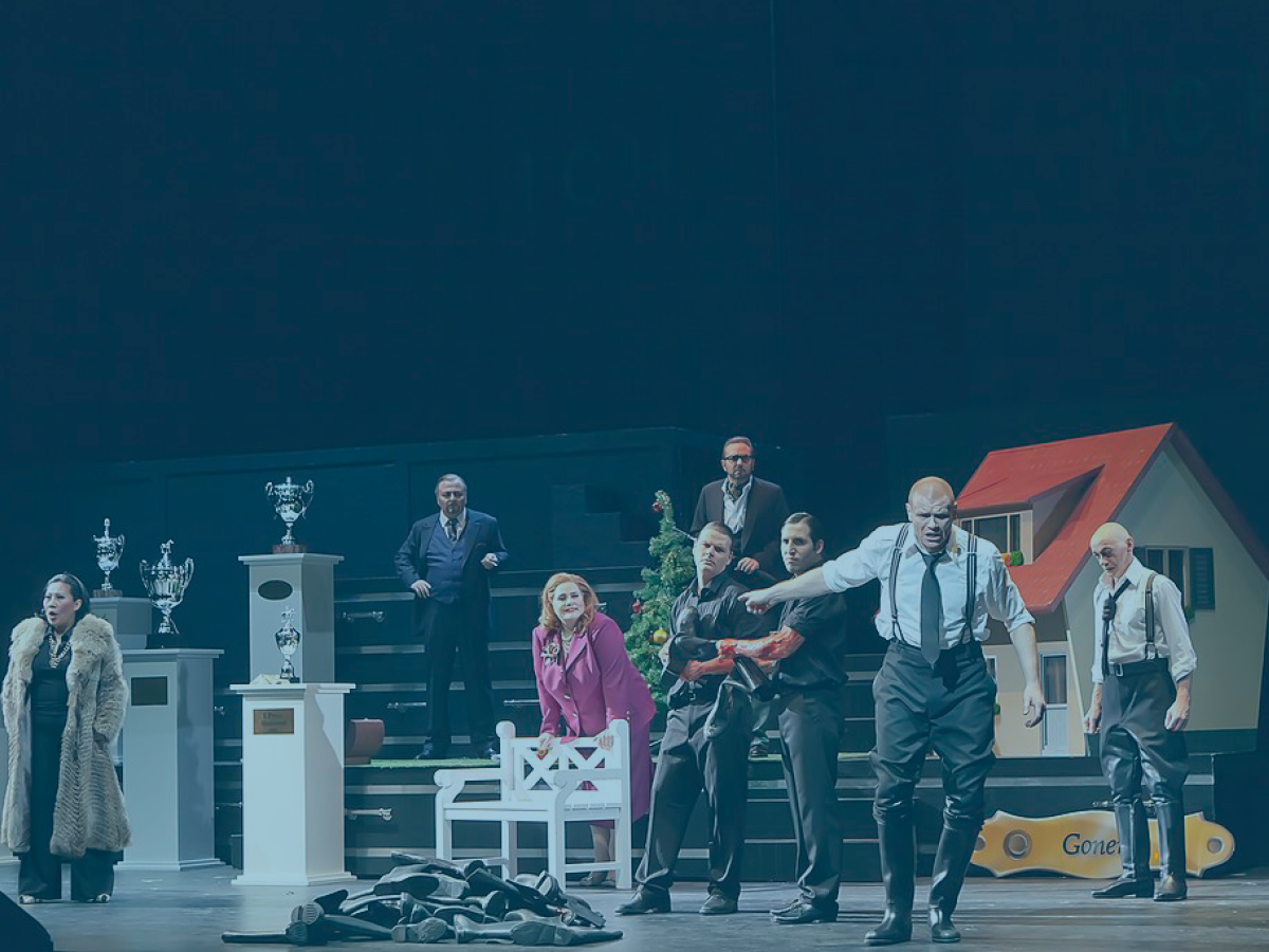 A modern staging of King Lear has the cast across the page. King Lear is front of stage gesturing while the others look on