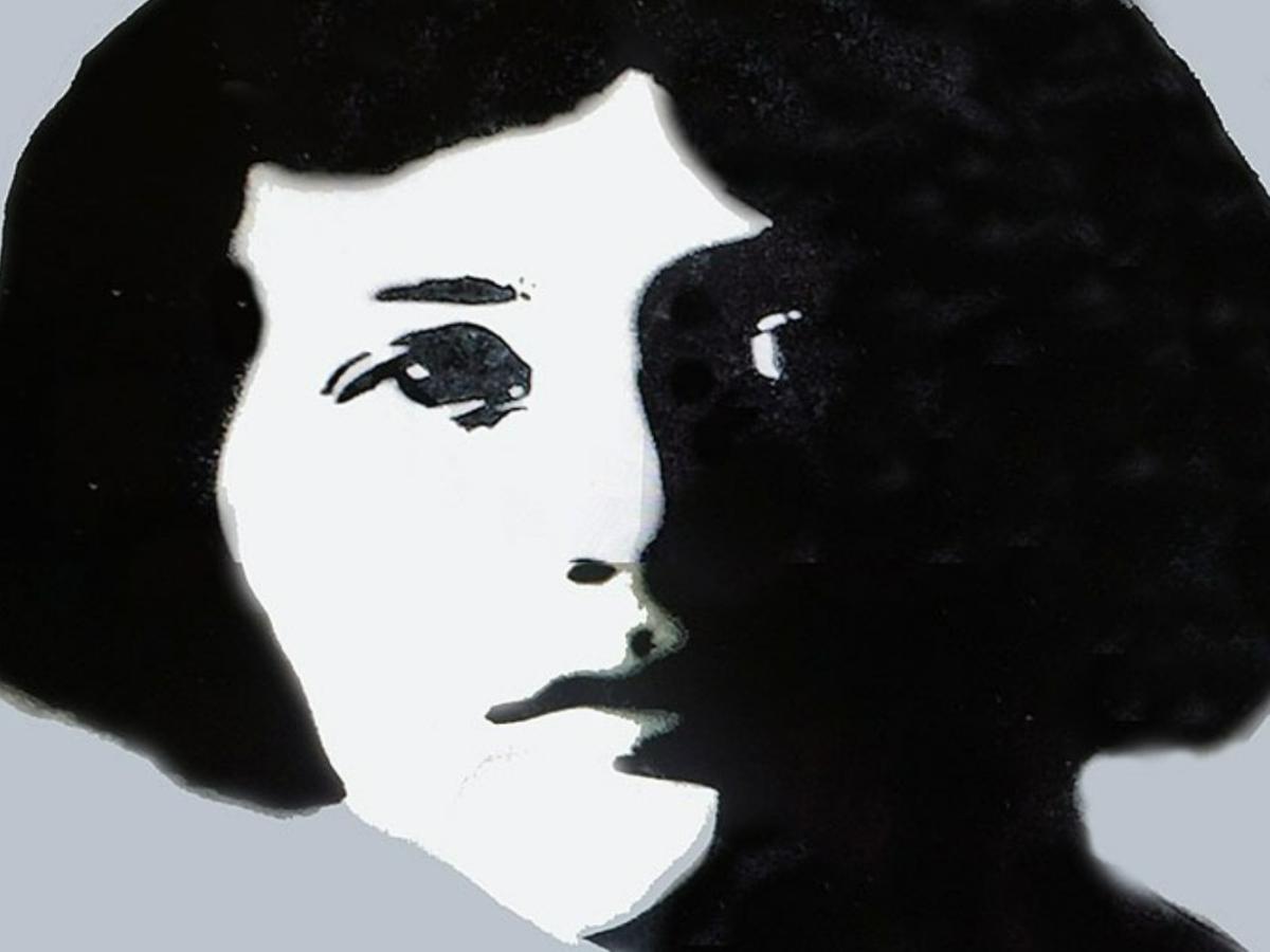 A monotone street mural of a young woman looking fiercely at the viewer.