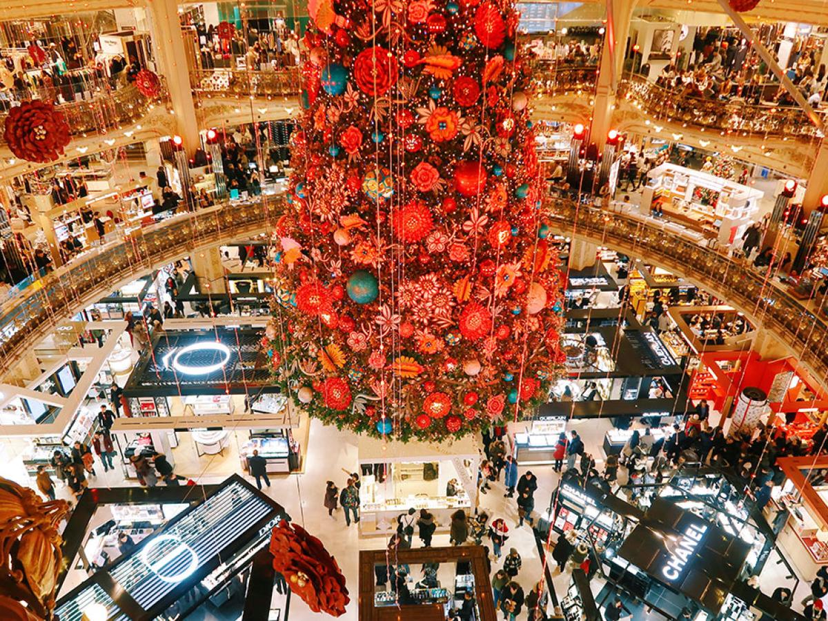 Looking down a red shiny christmas tree in the centre of a department store gallery.
