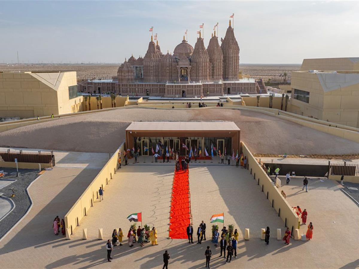A red carpet lies on a grand entrance to a newly constructed Hindu temple.