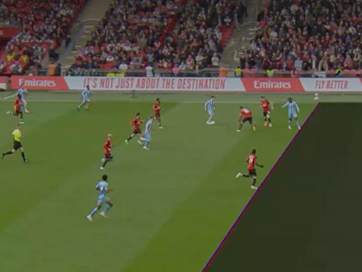 A TV screen shows a football match with a superimposed diagonal line dividing the pitch.