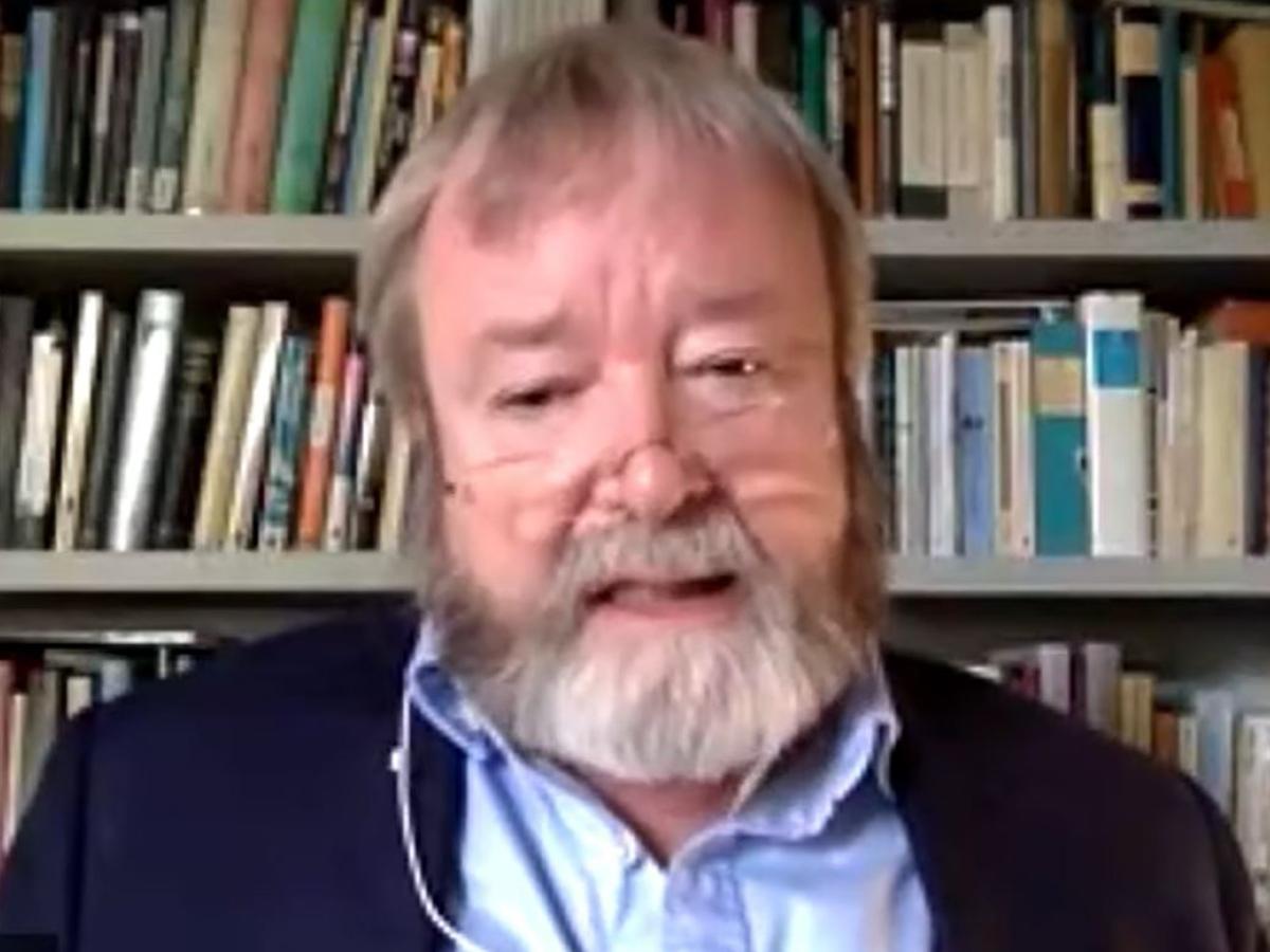 A man sits and talks to the camera.