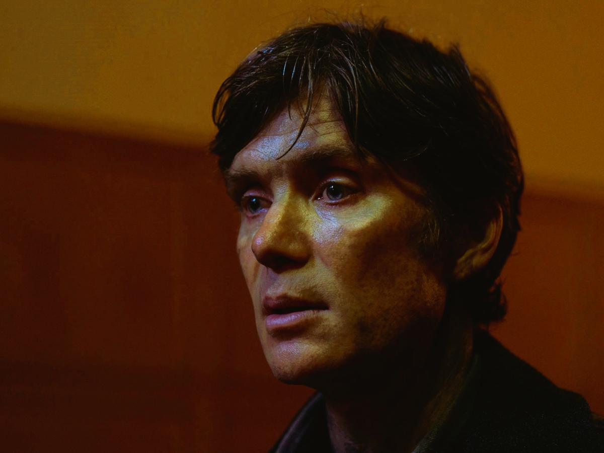The gaunt face of a dishevelled man stares into the distance