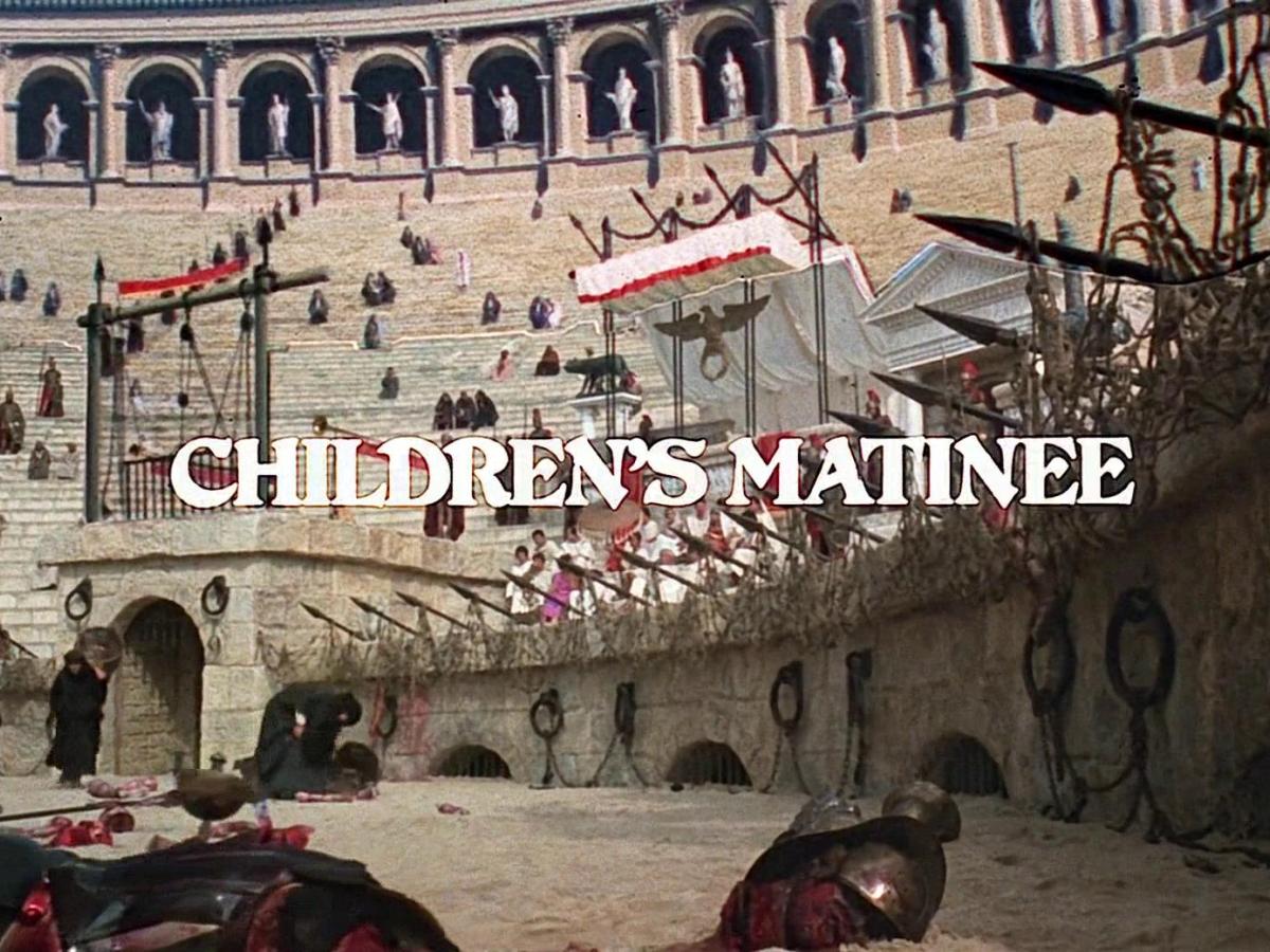 A movie still shows a Roman amphitheatre, covered in body parts, over which a sign reads 'children's matinee'.