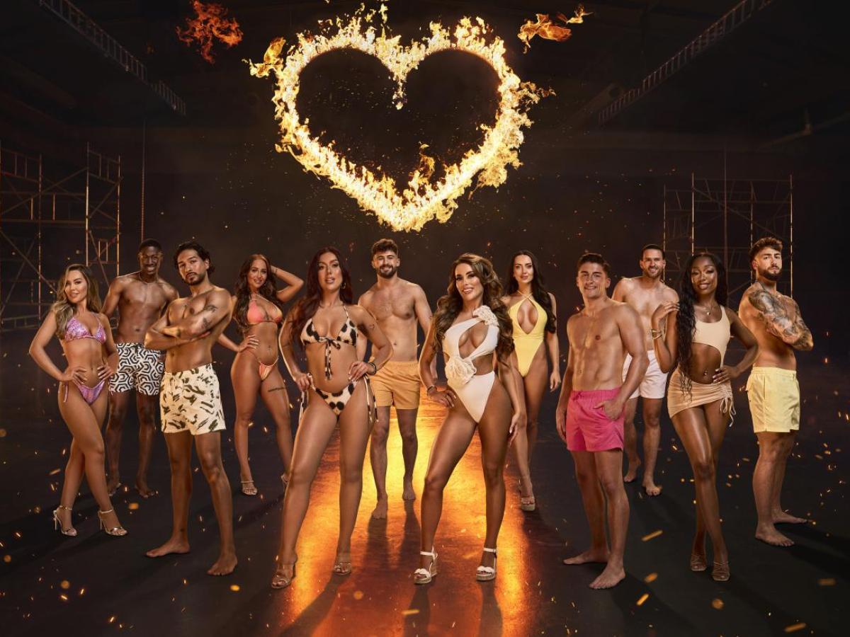 A Composite image of Love Island contestants stand together in a group under a fiery heart.