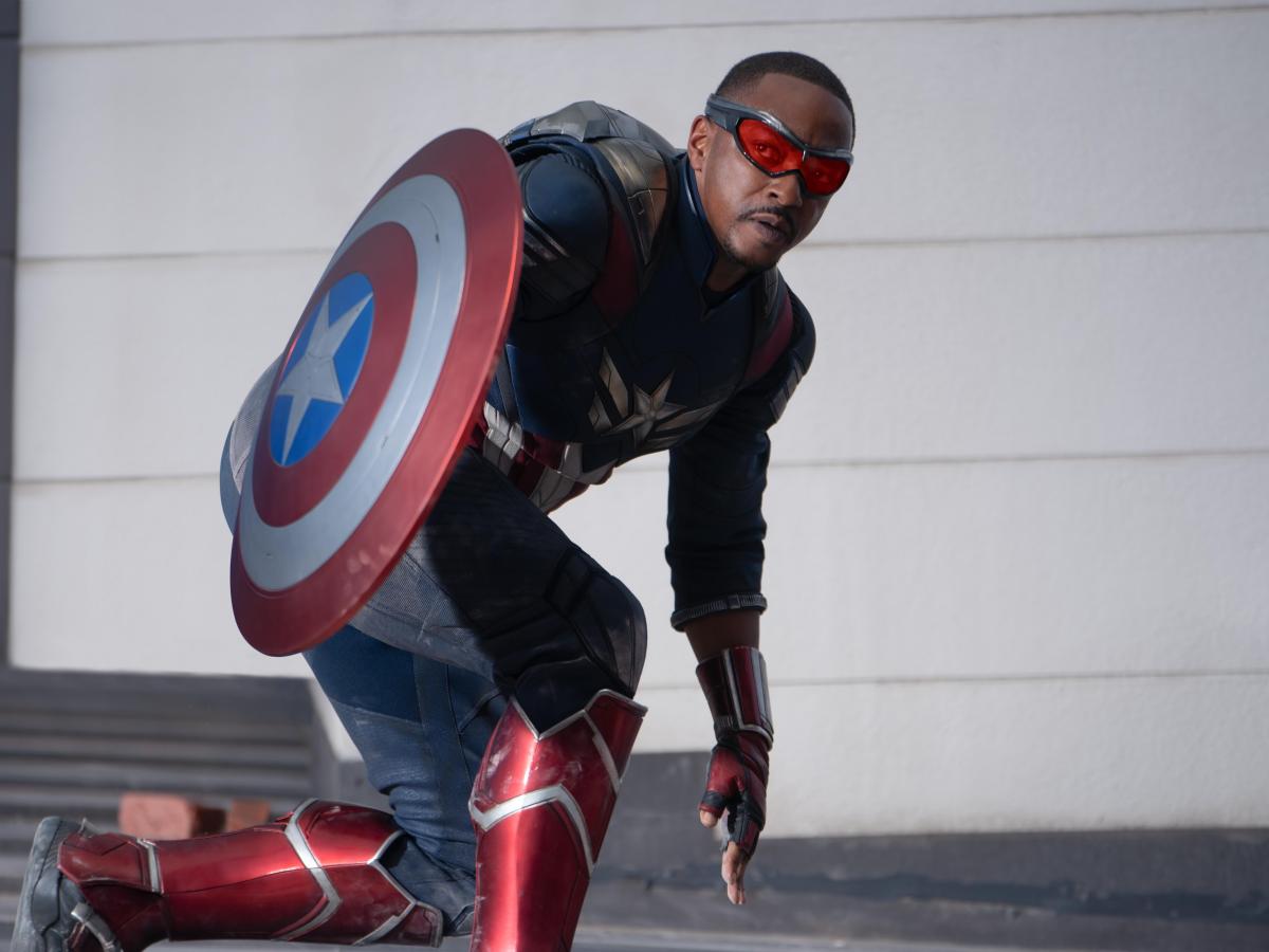 Captain America crouches expectantly beside his shield
