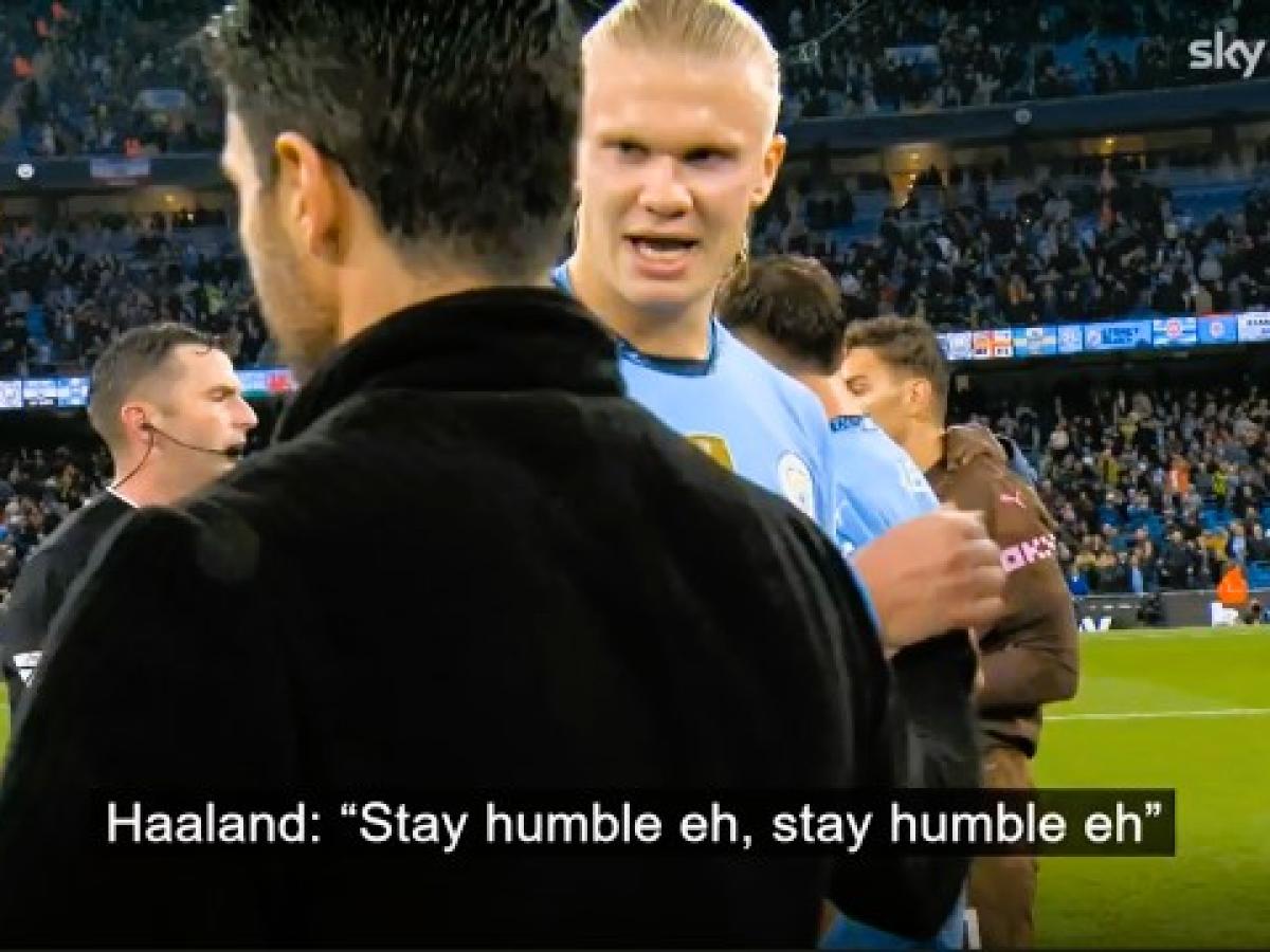 A TV screengrab shows a football manager walking while a passing rival player says (captioned) 'stay humble'.