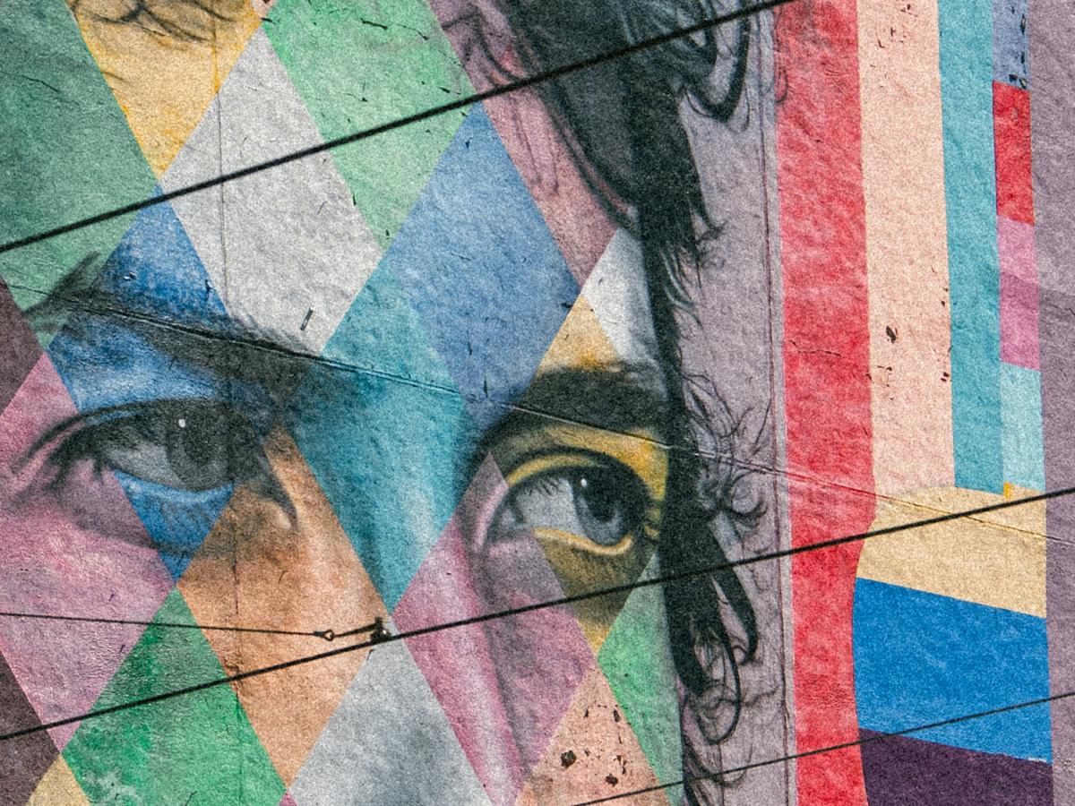 A colorful mural depicts the eyes of Bob Dylan staring to the side.