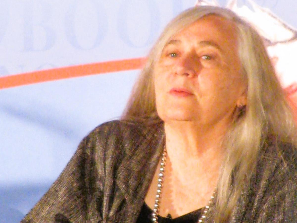 An author sits and listens.