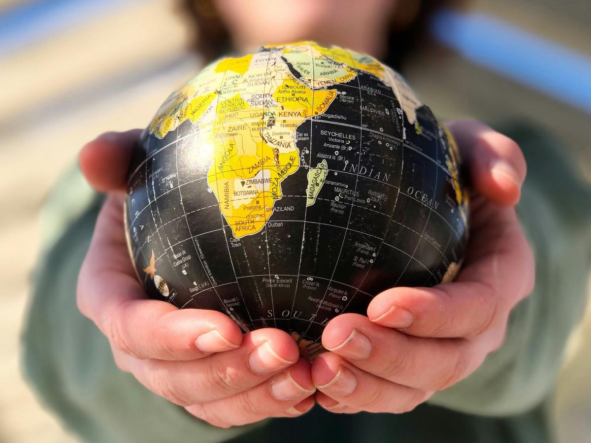 A small globe held in the hands.