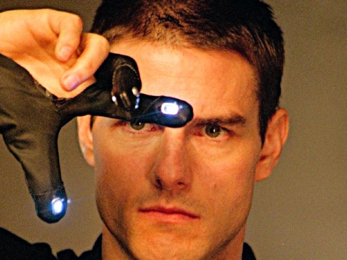 Tom Cruise gestures with his fingers in an e-glove in front of his face