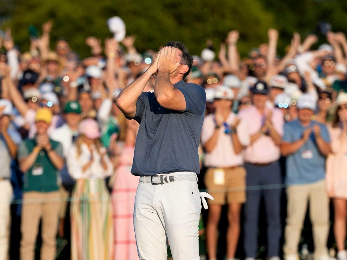A golf clutches his face after winning a competition