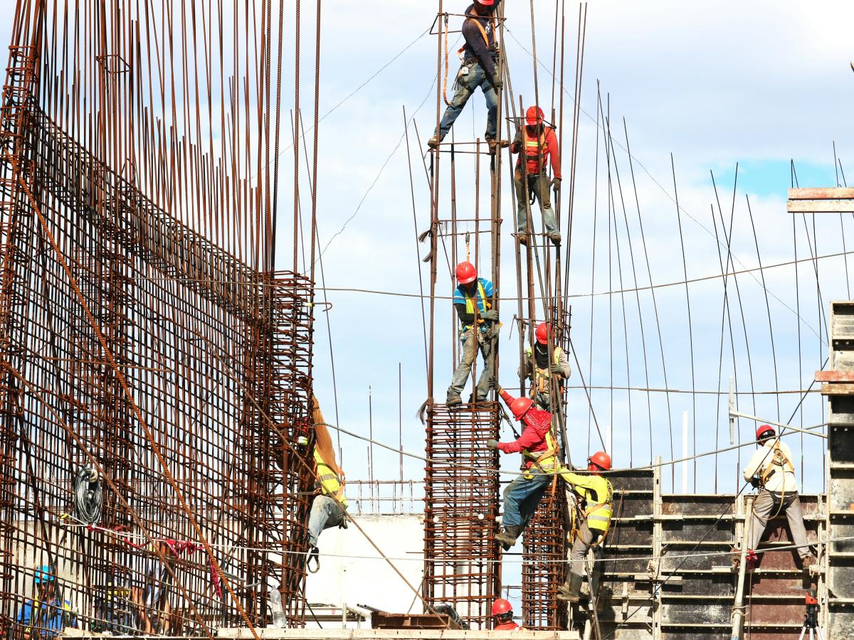 Construction worker climb a steel framework.