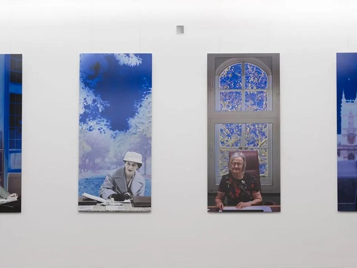 A paiting shows four panels featuring women lawyers over a century