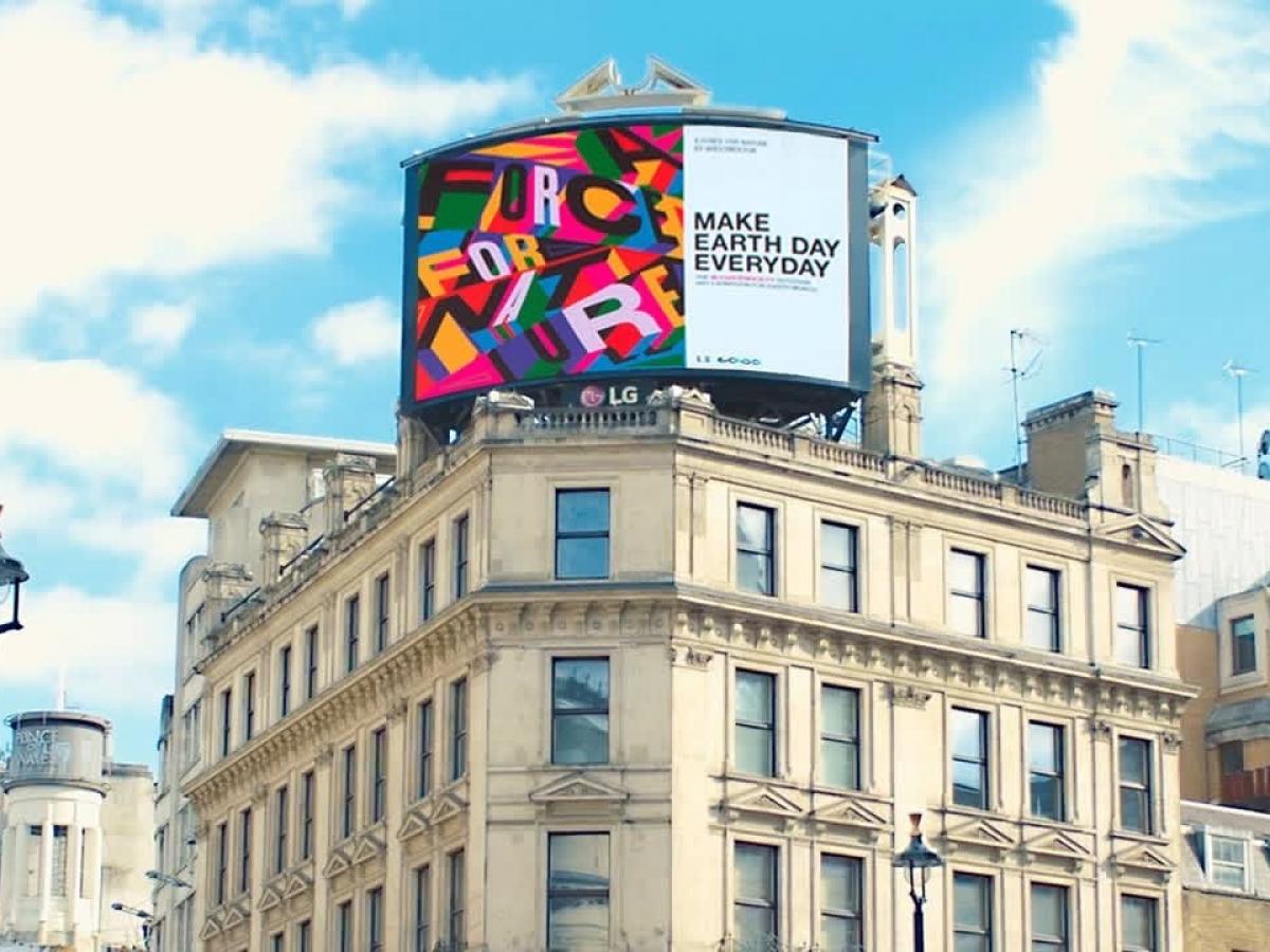 A digital billboard on top of a London building reads: Make Earth Day Everyday.