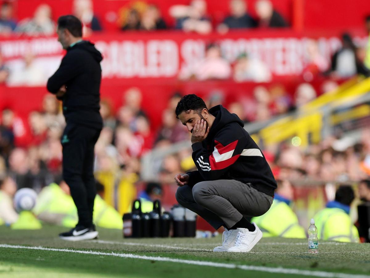 A dejected football coach squats by the byline.