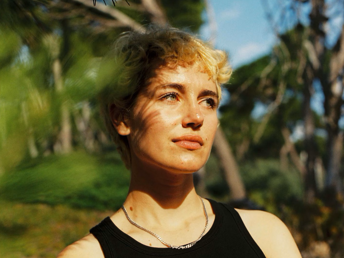 A woman stares away from the camera