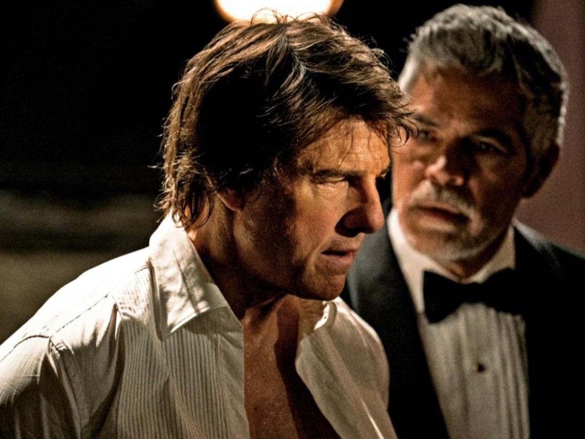Tom Cruise playing Ethan Hunt in an open necked shirt looks perplexed.