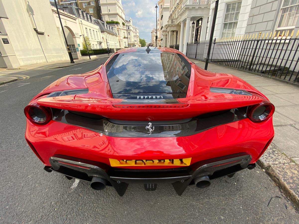 A red Ferrari parked on a posh London Street